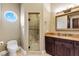 Bathroom with shower, toilet, vanity, and a large mirror at 3495 Pama Ln, Las Vegas, NV 89120