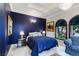 Blue bedroom with a comfortable bed and marble floors at 3495 Pama Ln, Las Vegas, NV 89120