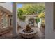 Serene courtyard with a central water fountain and arched passageway at 3495 Pama Ln, Las Vegas, NV 89120