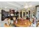 Elegant dining area in kitchen with large round table and chandelier at 3495 Pama Ln, Las Vegas, NV 89120