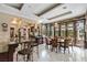 Kitchen dining area with round table, chandelier, and access to patio at 3495 Pama Ln, Las Vegas, NV 89120