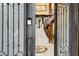 View through double doors into a grand foyer with marble floors and staircase at 3495 Pama Ln, Las Vegas, NV 89120