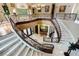 View of a large, curved marble staircase in a luxury home at 3495 Pama Ln, Las Vegas, NV 89120