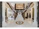 Elegant double staircase with ornate railings and marble flooring at 3495 Pama Ln, Las Vegas, NV 89120