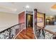 Long hallway with hardwood floors and ornate railings at 3495 Pama Ln, Las Vegas, NV 89120