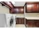 Well-appointed laundry room with washer, dryer, and ample cabinetry at 3495 Pama Ln, Las Vegas, NV 89120