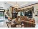 Elegant living room featuring a fireplace, ornate built-ins, and comfortable seating at 3495 Pama Ln, Las Vegas, NV 89120