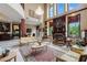 High-ceilinged living room with ornate furniture and a grand fireplace at 3495 Pama Ln, Las Vegas, NV 89120