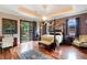 Luxurious main bedroom with hardwood floors, a large four-poster bed, and a fireplace at 3495 Pama Ln, Las Vegas, NV 89120