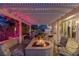 Lighted outdoor patio with fire pit and seating area at 3495 Pama Ln, Las Vegas, NV 89120