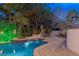 Luxury pool with spa and fountain at night at 3495 Pama Ln, Las Vegas, NV 89120