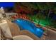 Aerial view of a luxurious pool at night at 3495 Pama Ln, Las Vegas, NV 89120