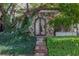 Ornate iron gate entry flanked by lush landscaping and stonework at 3495 Pama Ln, Las Vegas, NV 89120