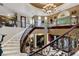 Impressive two-story staircase with ornate details and marble steps at 3495 Pama Ln, Las Vegas, NV 89120