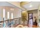 Elegant upper hall with hardwood floors, wrought iron railing, and natural light at 3495 Pama Ln, Las Vegas, NV 89120