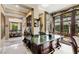 Built-in wet bar with dark wood cabinetry and green marble countertop at 3495 Pama Ln, Las Vegas, NV 89120