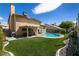 Spacious backyard oasis with a sparkling pool and artificial turf at 3817 W Red Coach Ave, North Las Vegas, NV 89031