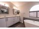 Modern bathroom with double vanity, soaking tub, and large shower at 3817 W Red Coach Ave, North Las Vegas, NV 89031