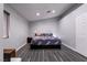 Large bedroom with king-size bed, gray walls, and wood-look floors at 3817 W Red Coach Ave, North Las Vegas, NV 89031