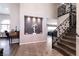 Entryway with gray tiled floors, a statement staircase, and unique decor at 3817 W Red Coach Ave, North Las Vegas, NV 89031