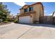 Two-story house with a white garage door and gated driveway at 3817 W Red Coach Ave, North Las Vegas, NV 89031