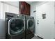 Laundry room with LG washer and dryer, and wood cabinets at 3817 W Red Coach Ave, North Las Vegas, NV 89031