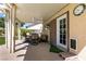 Covered patio with outdoor dining furniture, providing a shaded space for relaxation at 3817 W Red Coach Ave, North Las Vegas, NV 89031