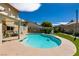 Relaxing kidney-shaped pool surrounded by a spacious patio and lush landscaping at 3817 W Red Coach Ave, North Las Vegas, NV 89031