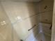 Walk-in shower with tiled walls and grab bars at 3941 Dennis St, Pahrump, NV 89060