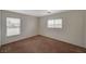 Well-lit bedroom with neutral walls and carpet, plus two windows at 3968 Moon Tango St, Las Vegas, NV 89129