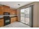 Kitchen with light wood cabinets, granite countertops, and black appliances at 3968 Moon Tango St, Las Vegas, NV 89129