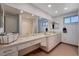 Spacious bathroom with double sinks and a very large mirror above the vanity at 4008 Snead Dr, Las Vegas, NV 89107