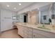 Bright bathroom features a long vanity with double sinks, marble countertop, and a large mirror at 4008 Snead Dr, Las Vegas, NV 89107