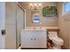 Bathroom featuring a white sink vanity, mirror, shower, toilet, and sunflower decoration at 4008 Snead Dr, Las Vegas, NV 89107