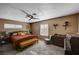 Bedroom featuring a queen size bed, two windows and furnishings like a bench and dressers at 4008 Snead Dr, Las Vegas, NV 89107