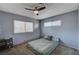 Bedroom featuring a window, and a bed with a green bedspread and grey and floral pillows at 4008 Snead Dr, Las Vegas, NV 89107