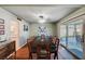 Traditional dining room featuring a long table, ceiling fan, and sliding door access to the backyard patio at 4008 Snead Dr, Las Vegas, NV 89107