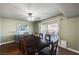 Well-lit dining area with a dark wood table, seating for ten, and backyard views through sliding glass doors at 4008 Snead Dr, Las Vegas, NV 89107