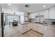 Bright kitchen with white cabinetry, tile flooring, and an adjacent dining area at 4008 Snead Dr, Las Vegas, NV 89107