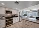 Modern kitchen featuring white cabinets, stainless steel appliances, and a tile backsplash at 4008 Snead Dr, Las Vegas, NV 89107