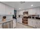 Updated kitchen featuring stainless steel appliances, white cabinets and subway tile, and granite counters at 4008 Snead Dr, Las Vegas, NV 89107