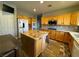 Eat-in kitchen with granite island and wood cabinets at 420 Rhythm St, Henderson, NV 89074