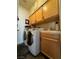 Laundry room with wood cabinets and washer/dryer hookups at 420 Rhythm St, Henderson, NV 89074