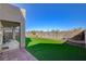 Spacious backyard with artificial turf and a covered patio at 422 Waterbrook Dr, Henderson, NV 89015