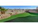 Landscaped backyard with artificial turf and decorative wall at 422 Waterbrook Dr, Henderson, NV 89015