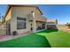 Backyard with covered patio, artificial turf and partial view of home at 422 Waterbrook Dr, Henderson, NV 89015