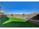 Landscaped backyard features synthetic grass and privacy walls at 422 Waterbrook Dr, Henderson, NV 89015