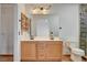 Bathroom featuring a double sink vanity, framed mirror, and stone-walled shower at 422 Waterbrook Dr, Henderson, NV 89015