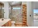 Bathroom featuring a stone-walled shower with a glass door and a vanity with a sink at 422 Waterbrook Dr, Henderson, NV 89015