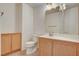 Clean bathroom with wood cabinets and a corner sink at 422 Waterbrook Dr, Henderson, NV 89015